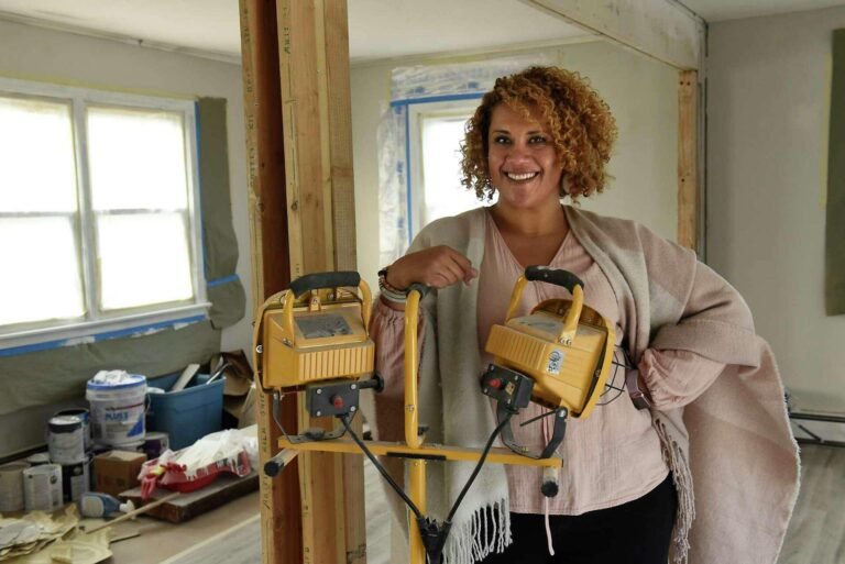 Female contractor renovating an investment property during a fix-and-flip project, preparing a room for resale after home improvements.