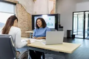 Business owner meeting with a financing professional to discuss business loan and funding options.