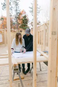Real estate investor and contractor reviewing renovation plans for an investment property