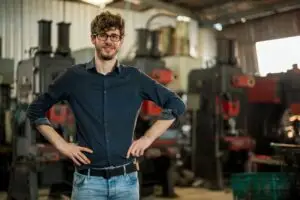 Small business owner with commercial equipment representing business term loan financing for equipment purchases and expansion.